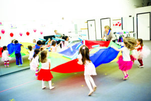 Kids playing with parachute in dance class